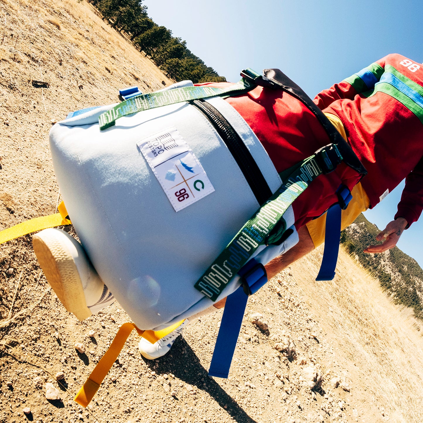 General lifestyle shot of Topo Designs x Colorado Rapids Rover Pack Classic in "Rio Red / Glacier Blue"