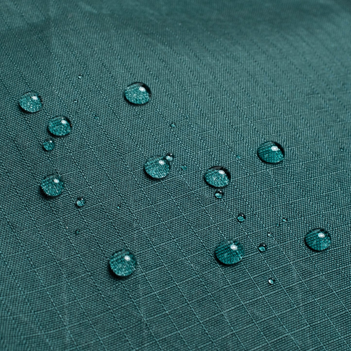 General back shot of Topo Designs Global Pro Travel Roller Bag showing water droplets on waterpoof material