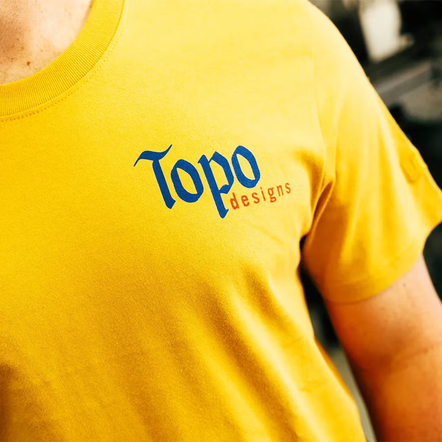 Lifestyle image of Topo Designs Peak Tee - Men's in "Goldenrod"