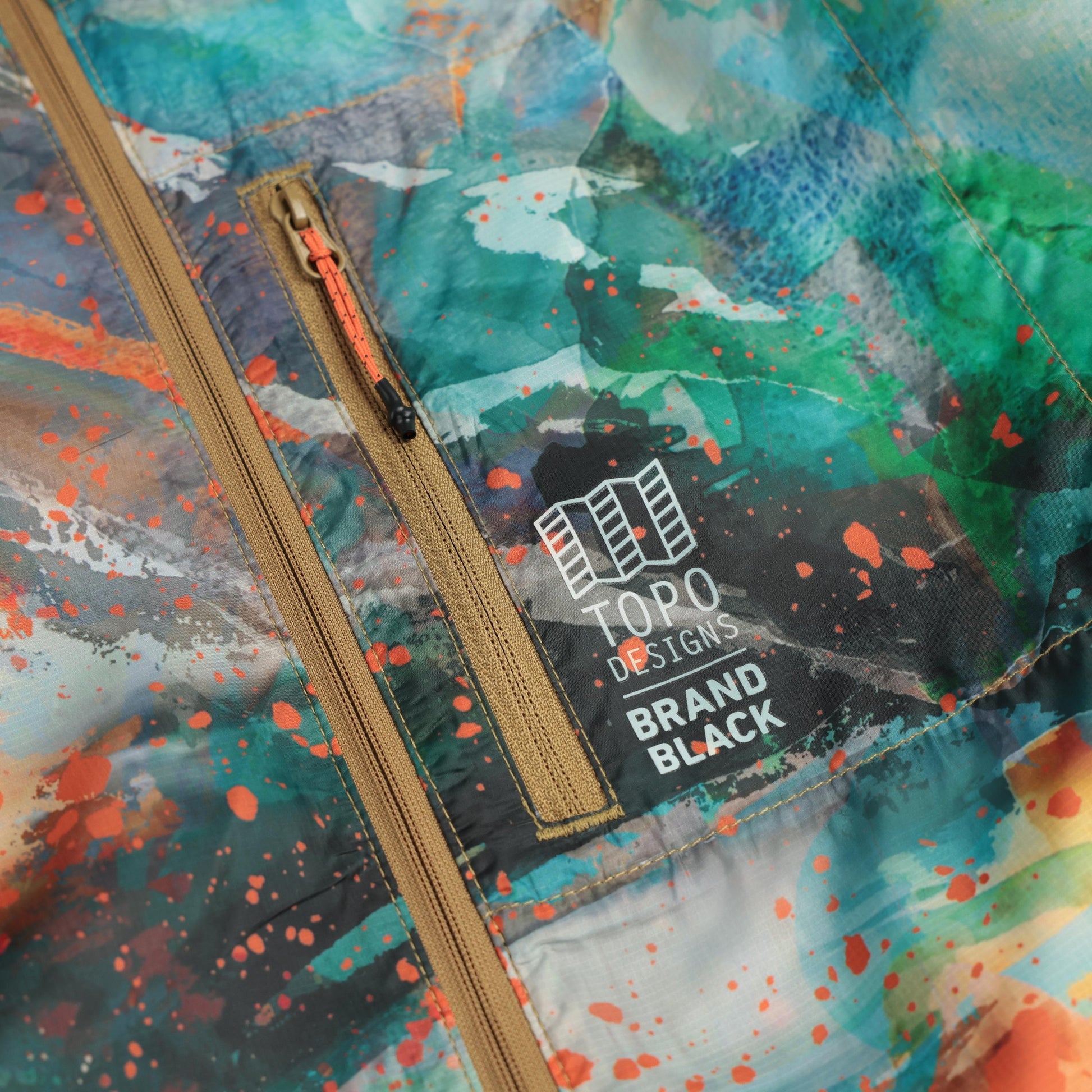 Detail shot of Topo Designs x Brand Black Global Ultralight Packable Jacket in "Koi"