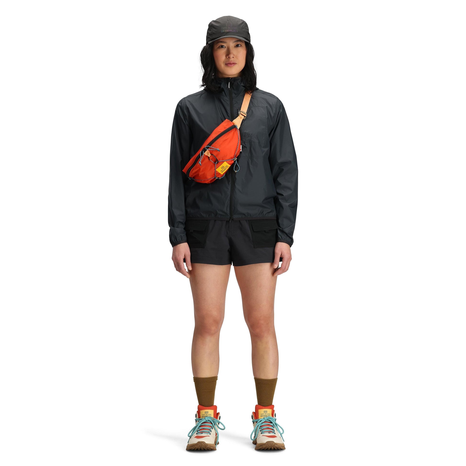 Model shot of Topo Designs x Brand Black Topolite Hip Pack in "Koi"