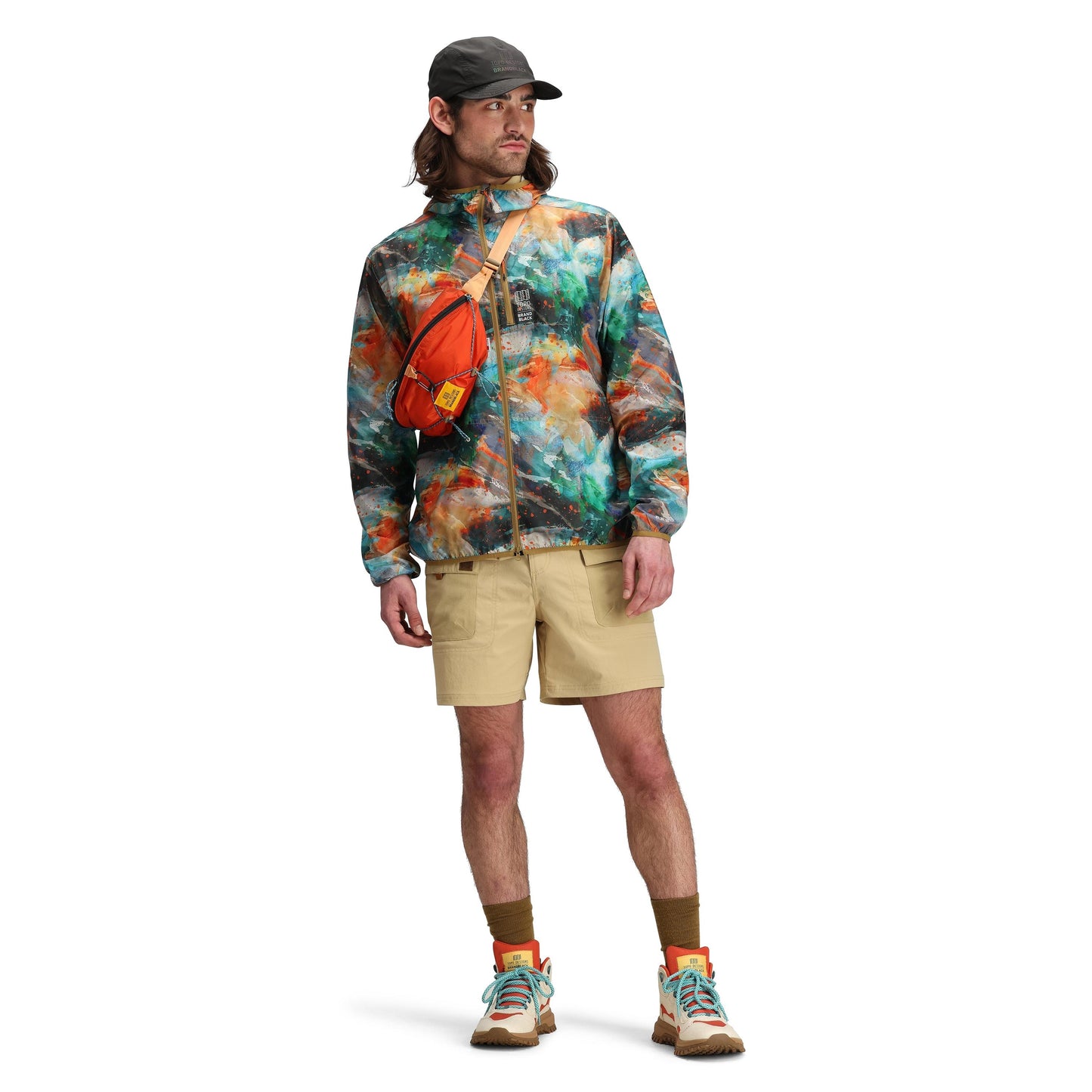 Model shot of Topo Designs x Brand Black Topolite Hip Pack in "Koi"