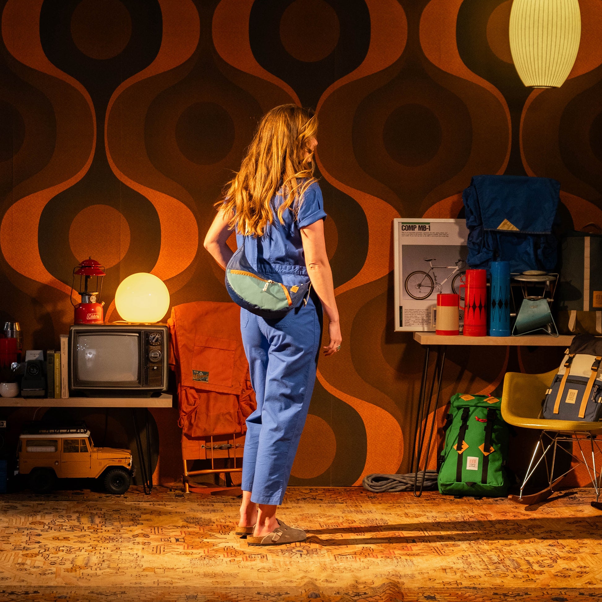 General in studio model image of female wearing Topo Designs Desert Coverall in "French Blue"