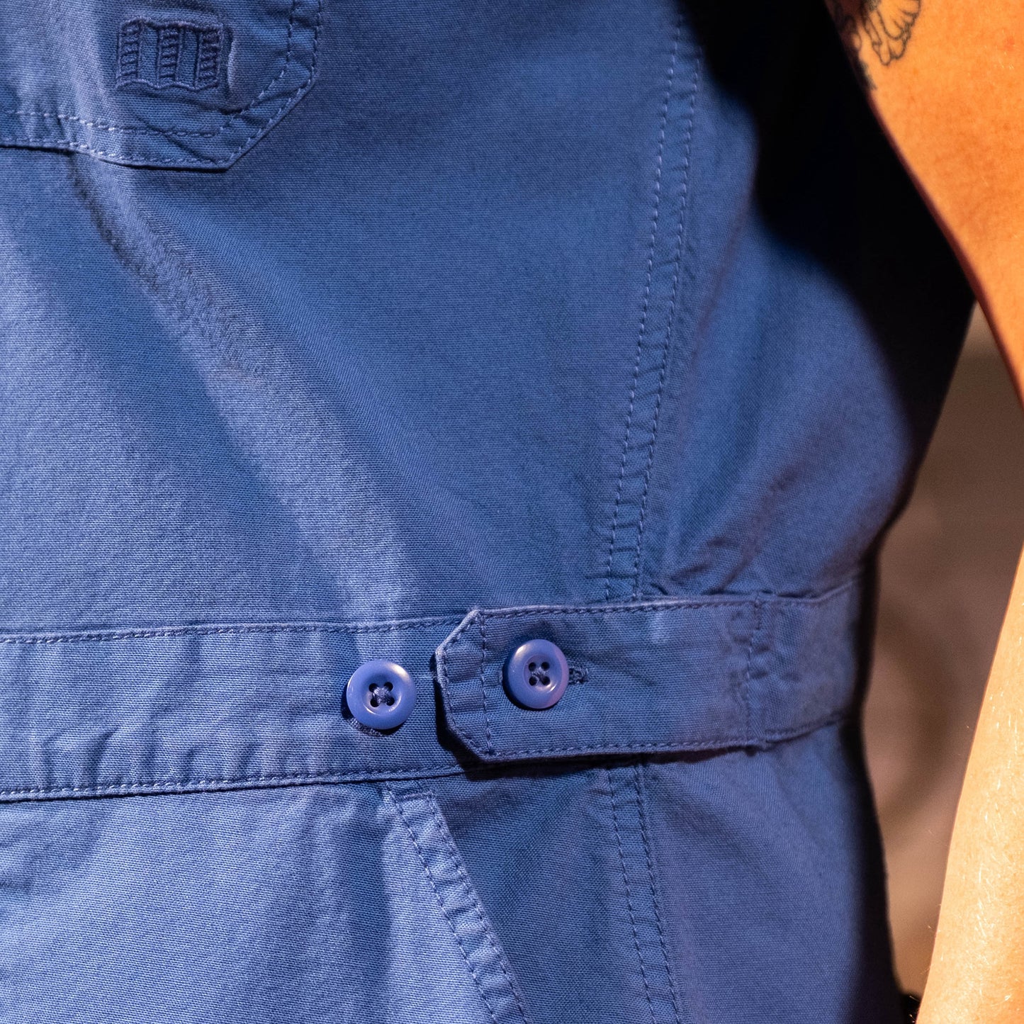 General in studio model detail image of female wearing Topo Designs Desert Coverall in "French Blue"
