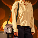 General photo of model in studio with Topo Designs Block Bag in "Nightshade / Slate"