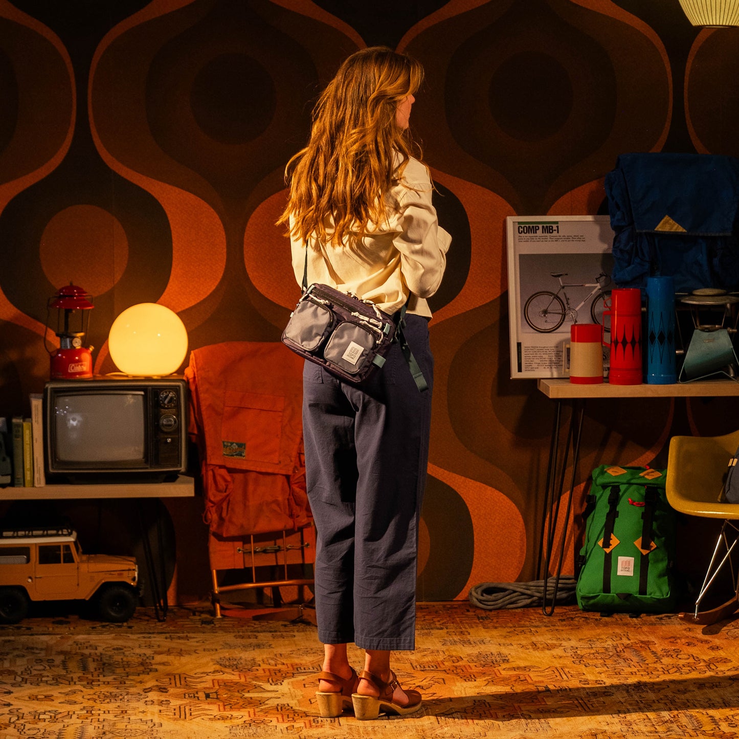 General photo of model in studio with Topo Designs Block Bag in "Nightshade / Slate"