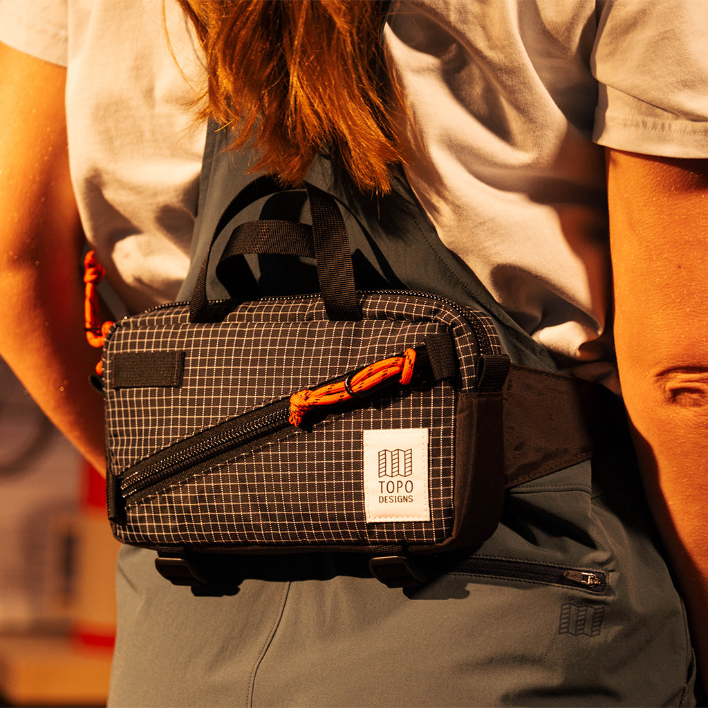 General front view of Topo Designs Mini Quick Pack in "Black Grid"