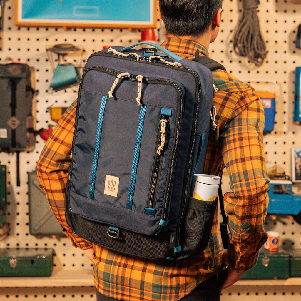 General model shot of Global Travel Bag 30L in "Navy" being worn in backpack configuration