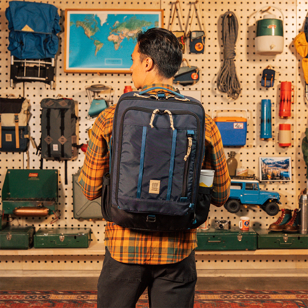 General model shot of Global Travel Bag 30L in "Navy" being worn in backpack configuration