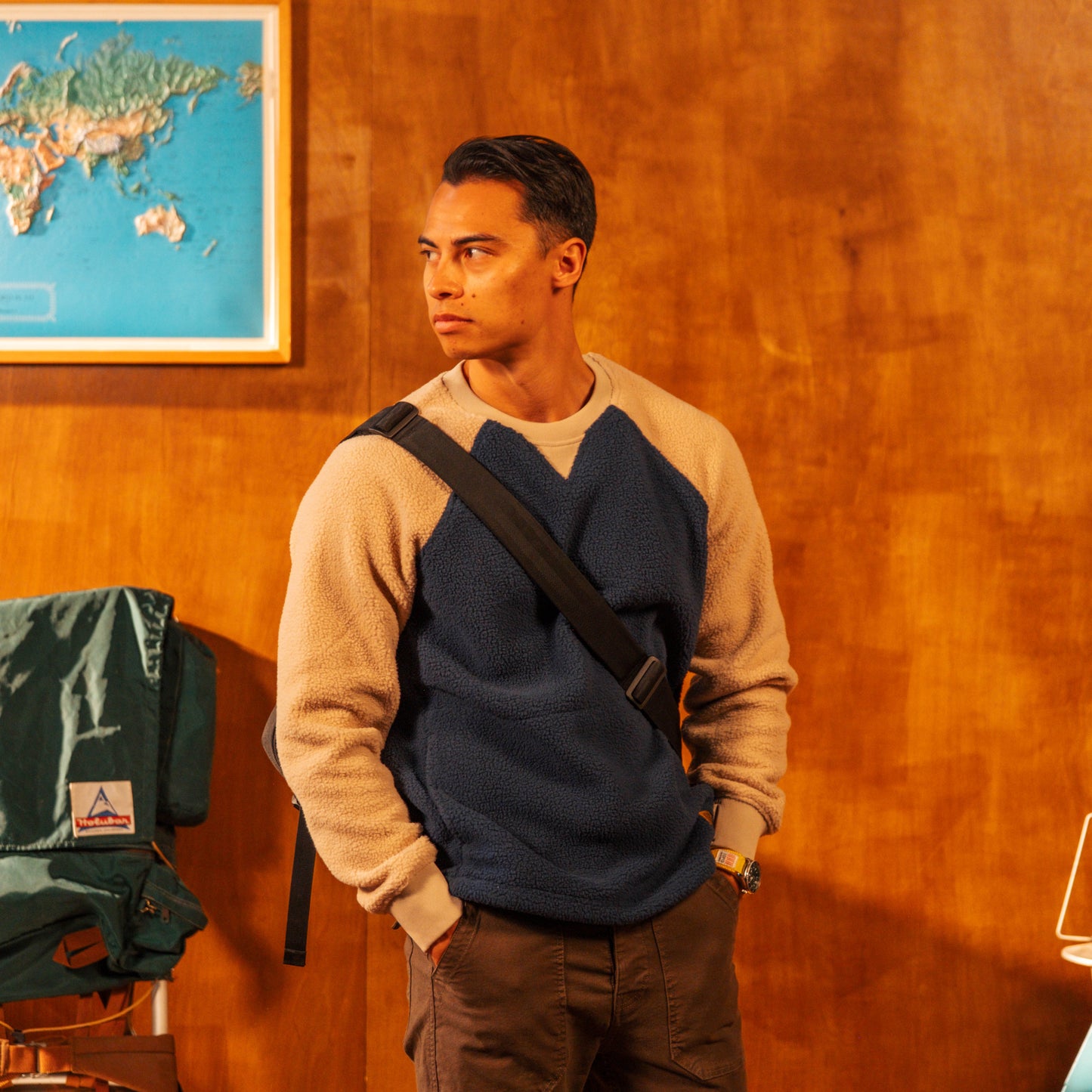 Man standing in a room with a world map on the wall