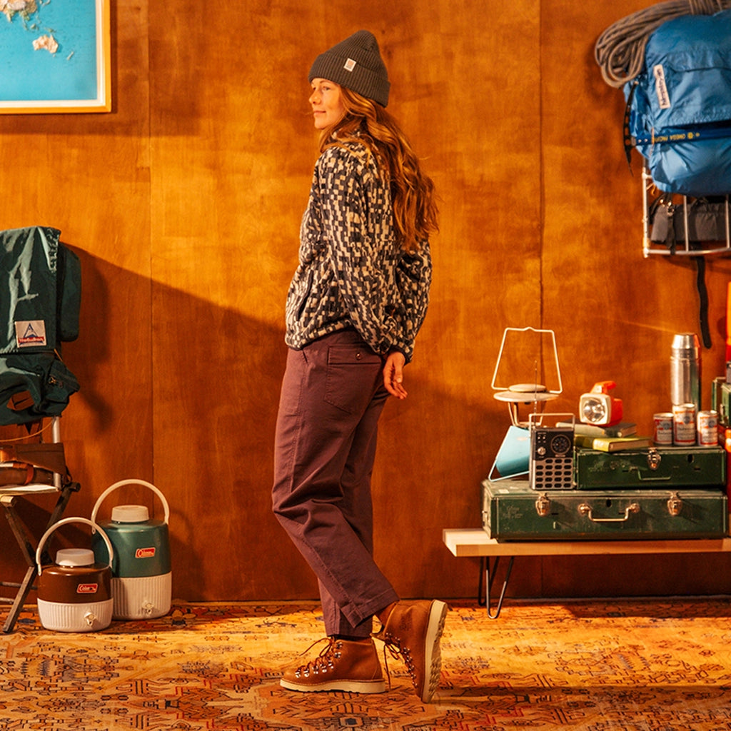 Person standing in a rustic room with camping gear and furniture wearing Field pants