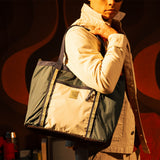 General lookbook model shot of Mountain Utility Tote in "Forest / Bone White"