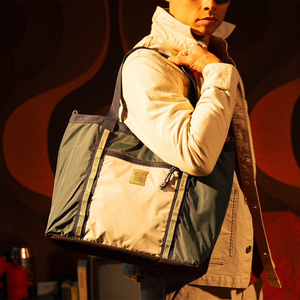 General lookbook model shot of Mountain Utility Tote in "Forest / Bone White"