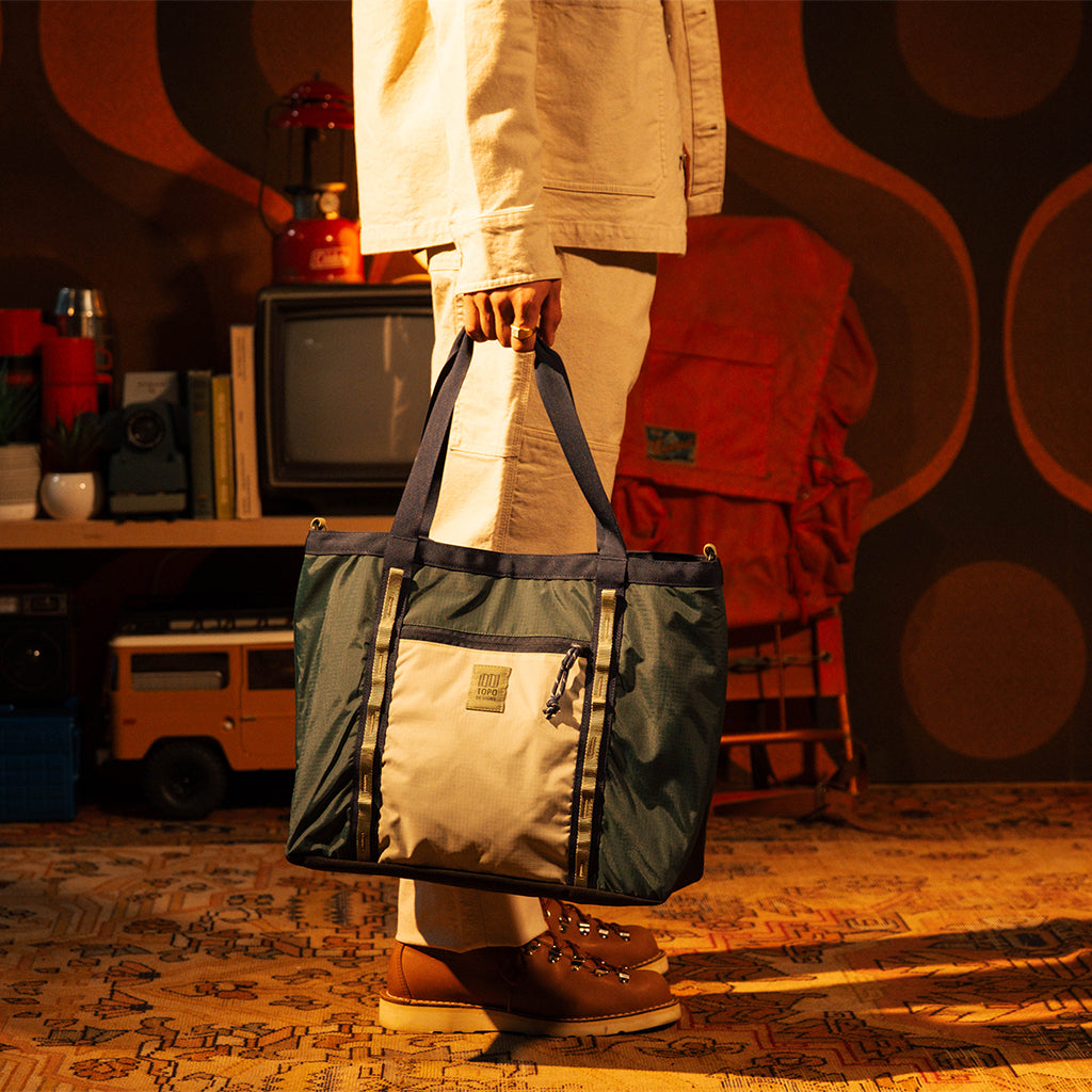 General lookbook model shot of Mountain Utility Tote in "Forest / Bone White"