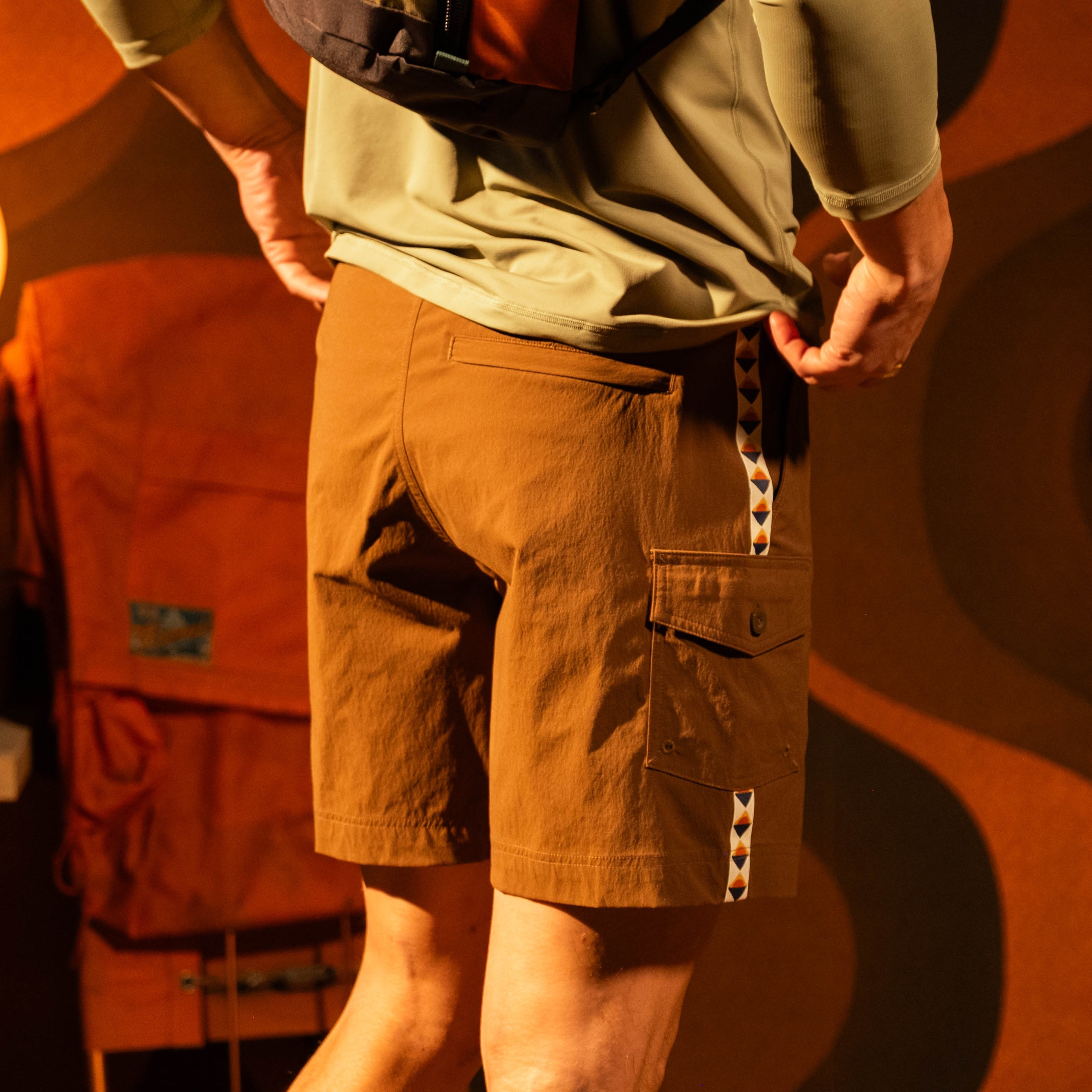 General model lifestyle photo of Topo Designs Mountain Wave Shorts on male model in "Desert Palm" [Model is 5'11", wearing size medium]