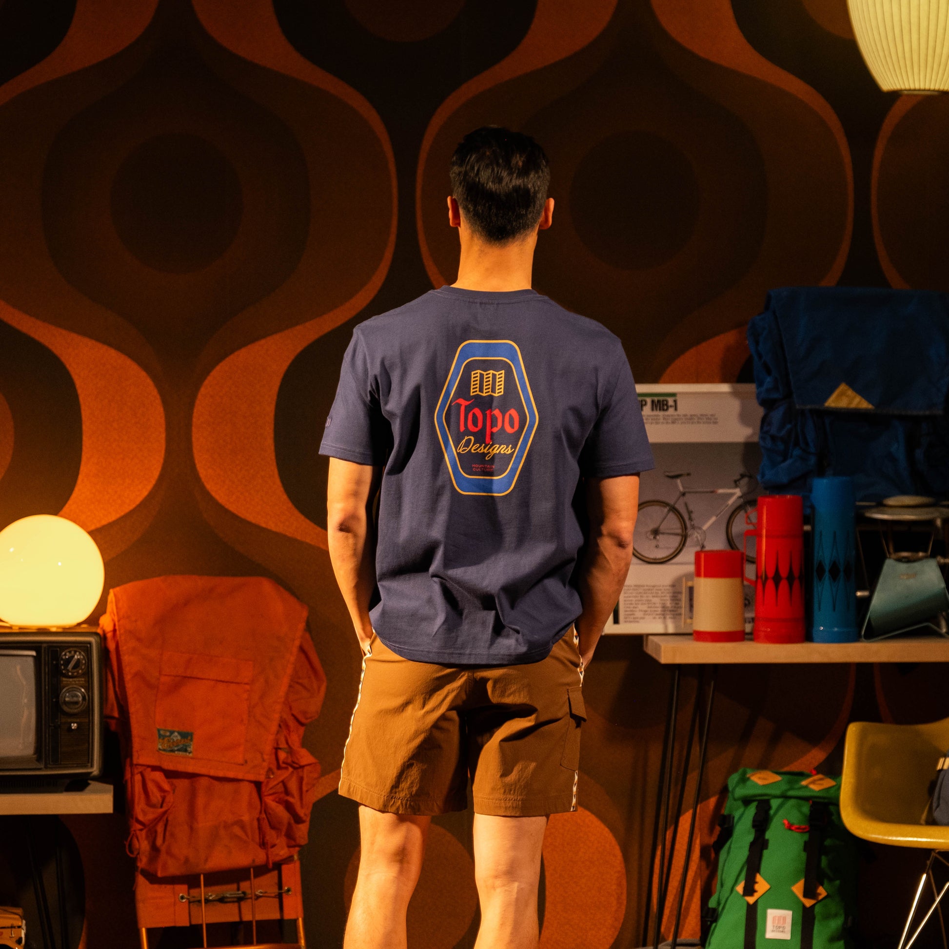 Lifestyle image in studio of male model wearing Topo Designs Draft Tee - Men's in "Midnight"