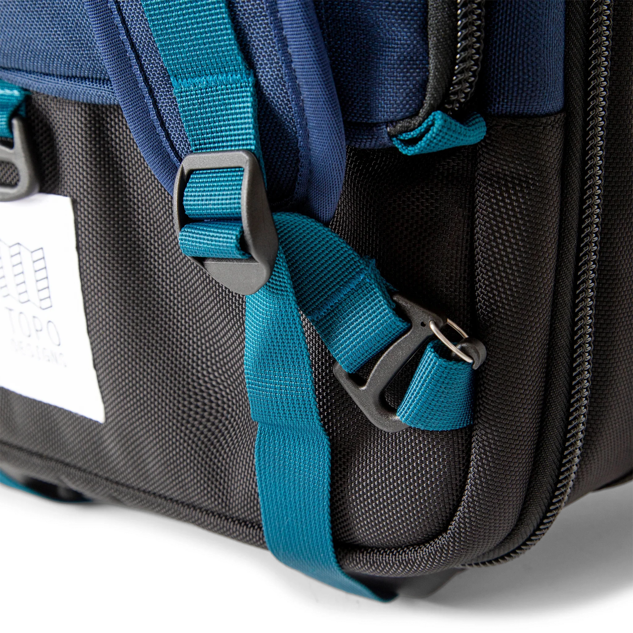 General shot of backpack strap attachment points on Topo Designs Global Travel Bag Roller durable carry-on convertible laptop rolling suitcase in Navy blue.