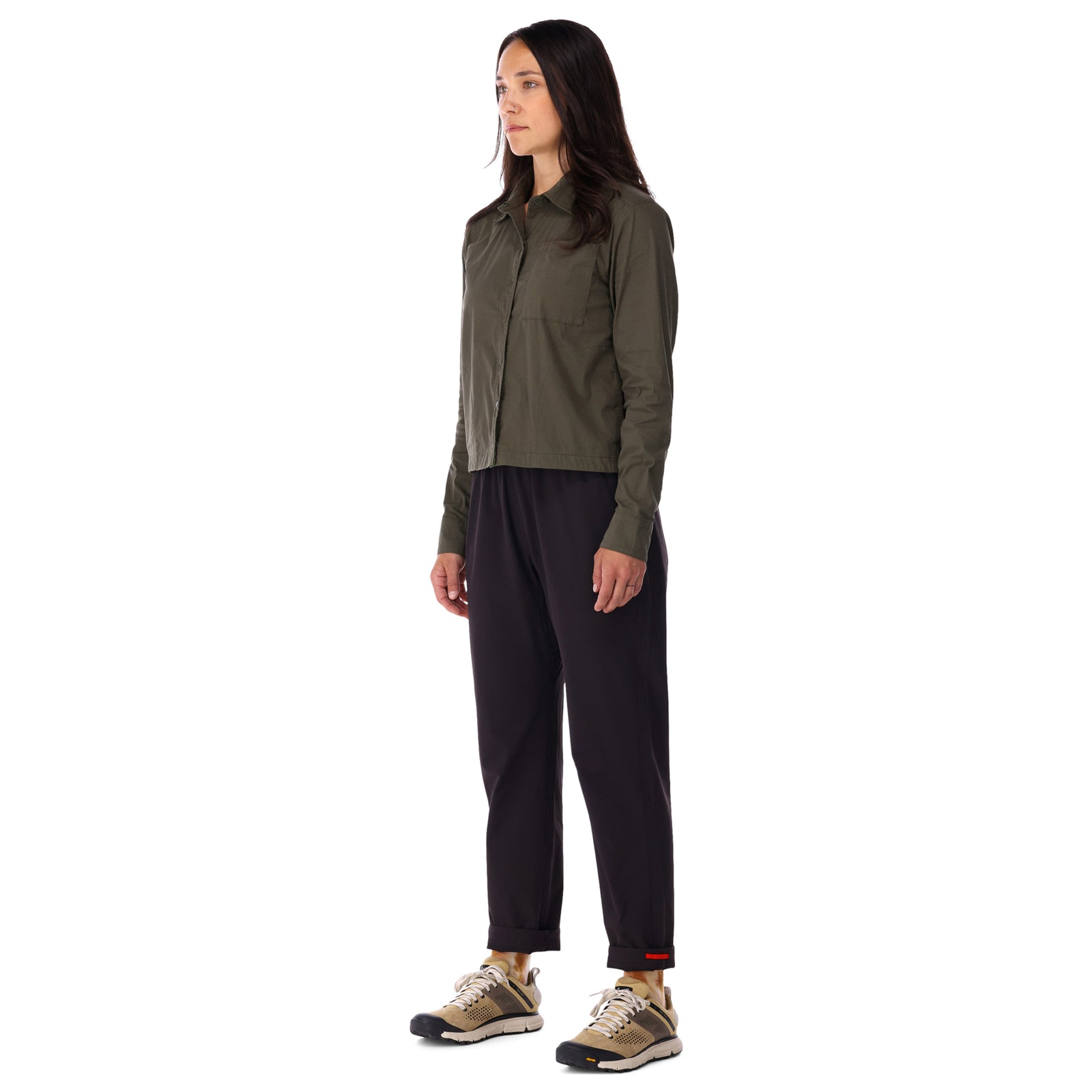 Side model shot of Topo Designs Women's Global long sleeve lightweight snap travel shirt in "olive" green on model front.