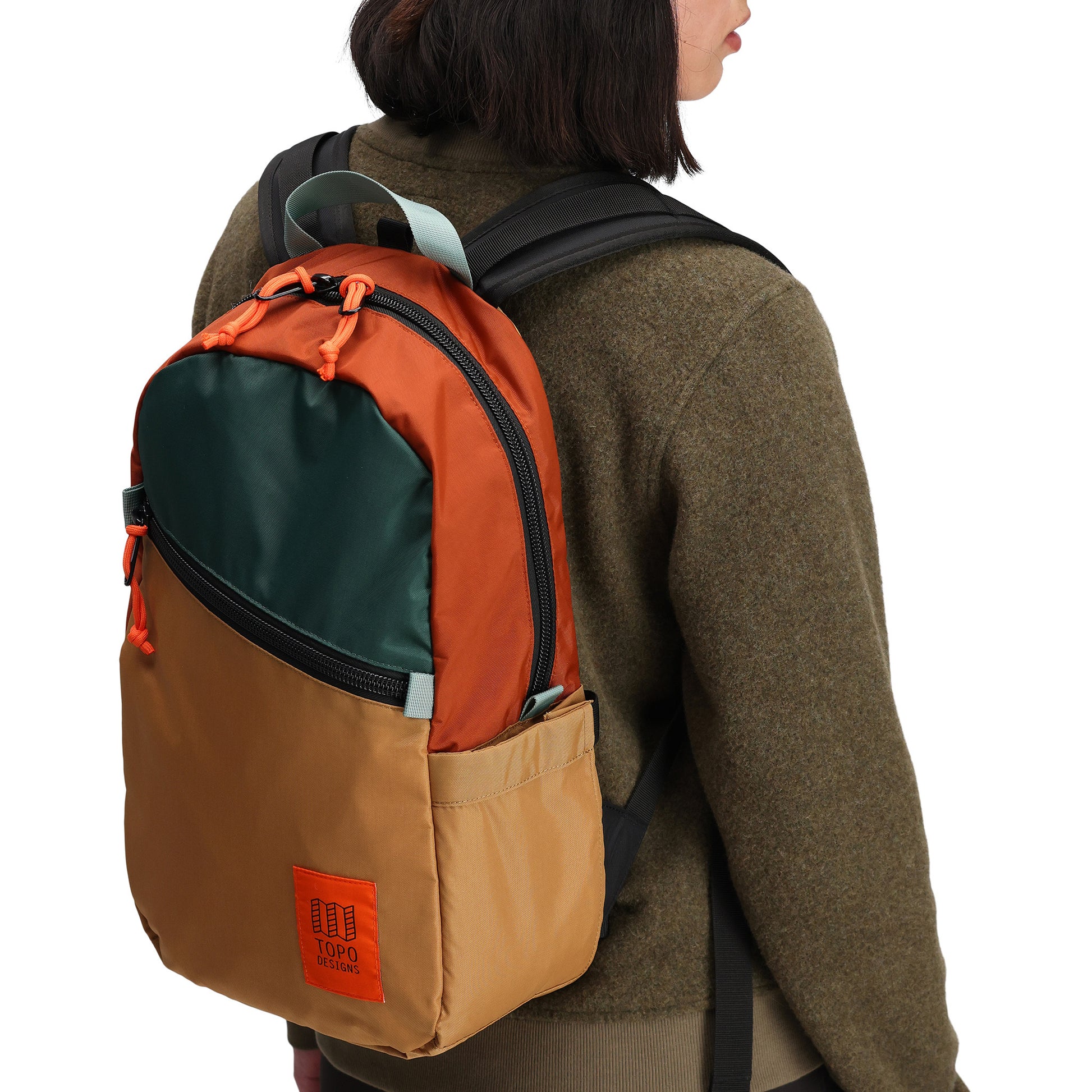 General front model shot of Topo Designs Light Pack in "Khaki / Forest"