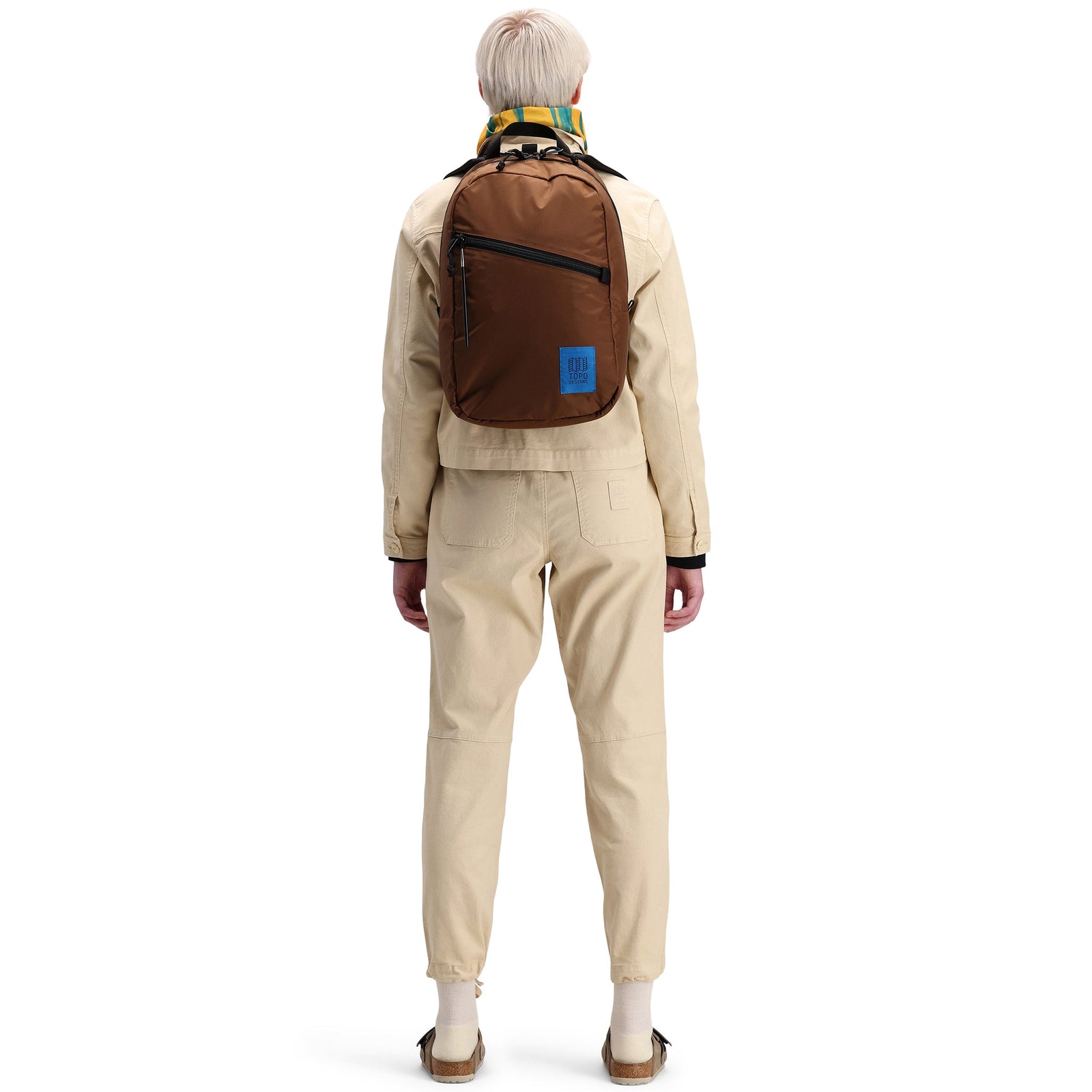 Back model shot of Topo Designs Women's Dirt Jacket 100% organic cotton shirt jacket in "sand" brown white