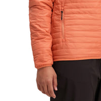 General detail shot of sleeve cuff & pocket on Topo Designs Women's Global Puffer recycled insulated packable Hoodie jacket in "coral" pink