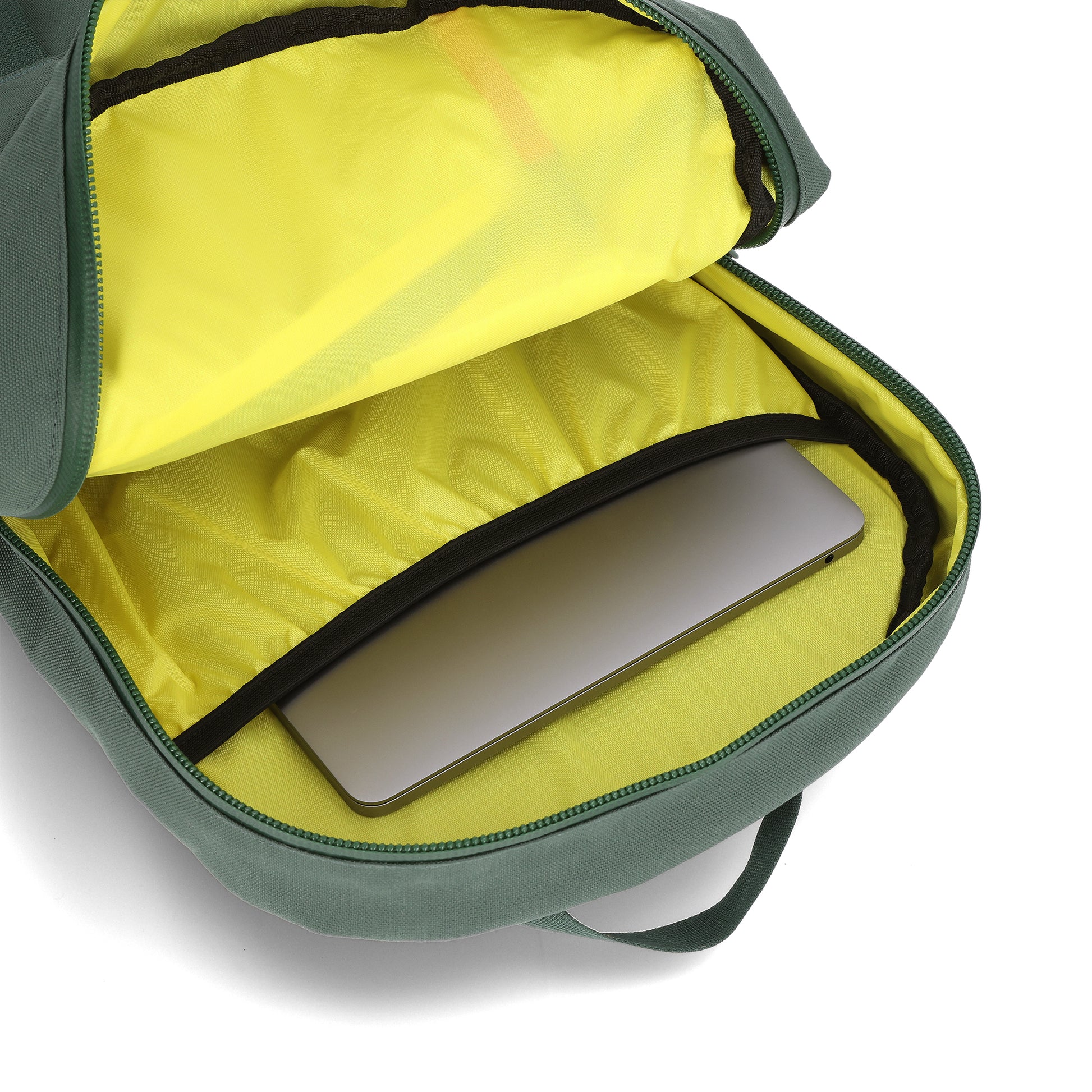 general shot Topo Designs Daypack Tech 100% recycled nylon backpack with external laptop access in "Forest" green.