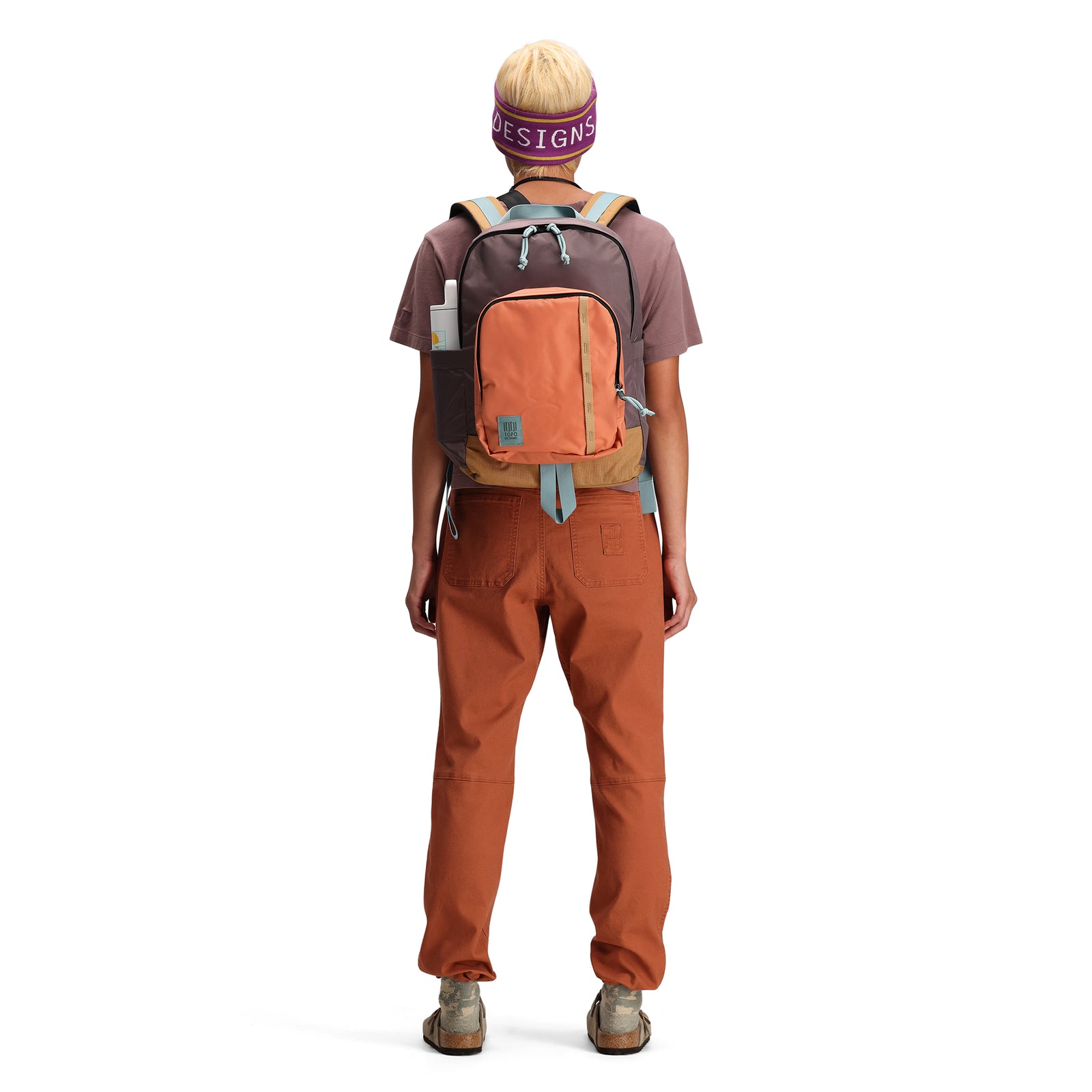Back model shot of Topo Designs Session Pack laptop backpack in "Coral / Peppercorn"