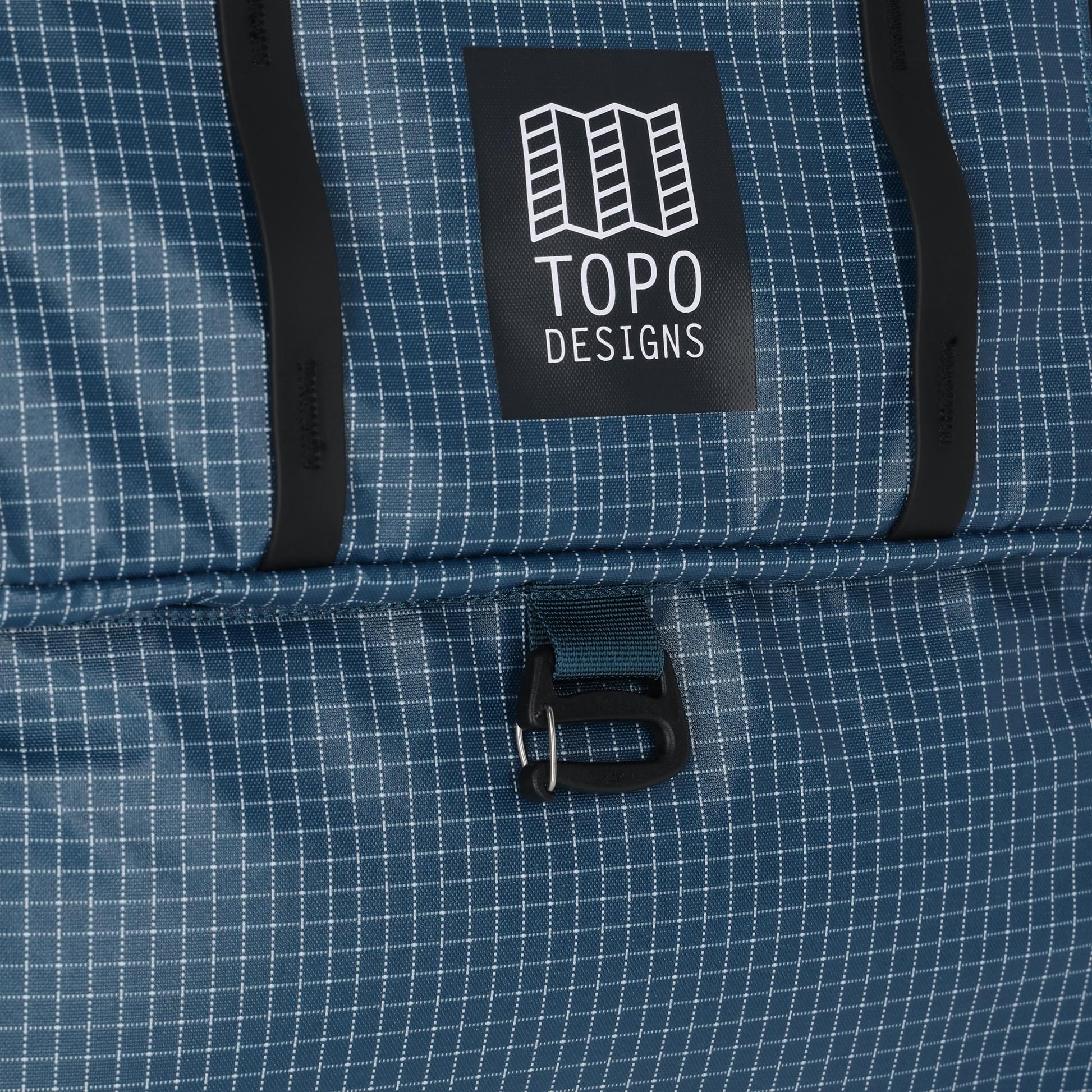 General detail shot of Topo Designs Apex Travel Roller Bag in "Pond Blue Grid"