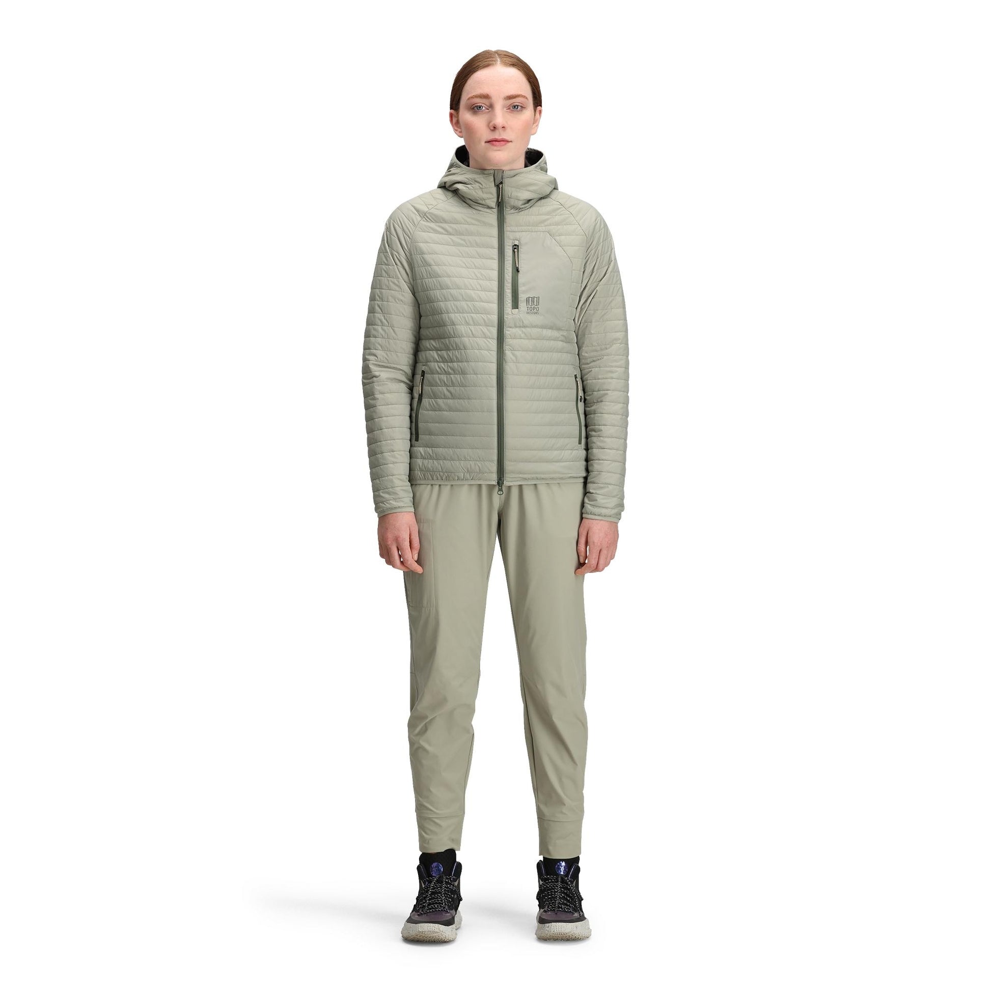 General front model shot of Topo Designs Global Puffer Hoodie - Women's in "Dried Sage"