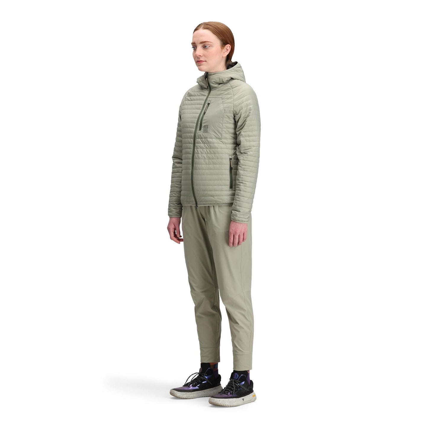 General side model shot of Topo Designs Global Puffer Hoodie - Women's in "Dried Sage"