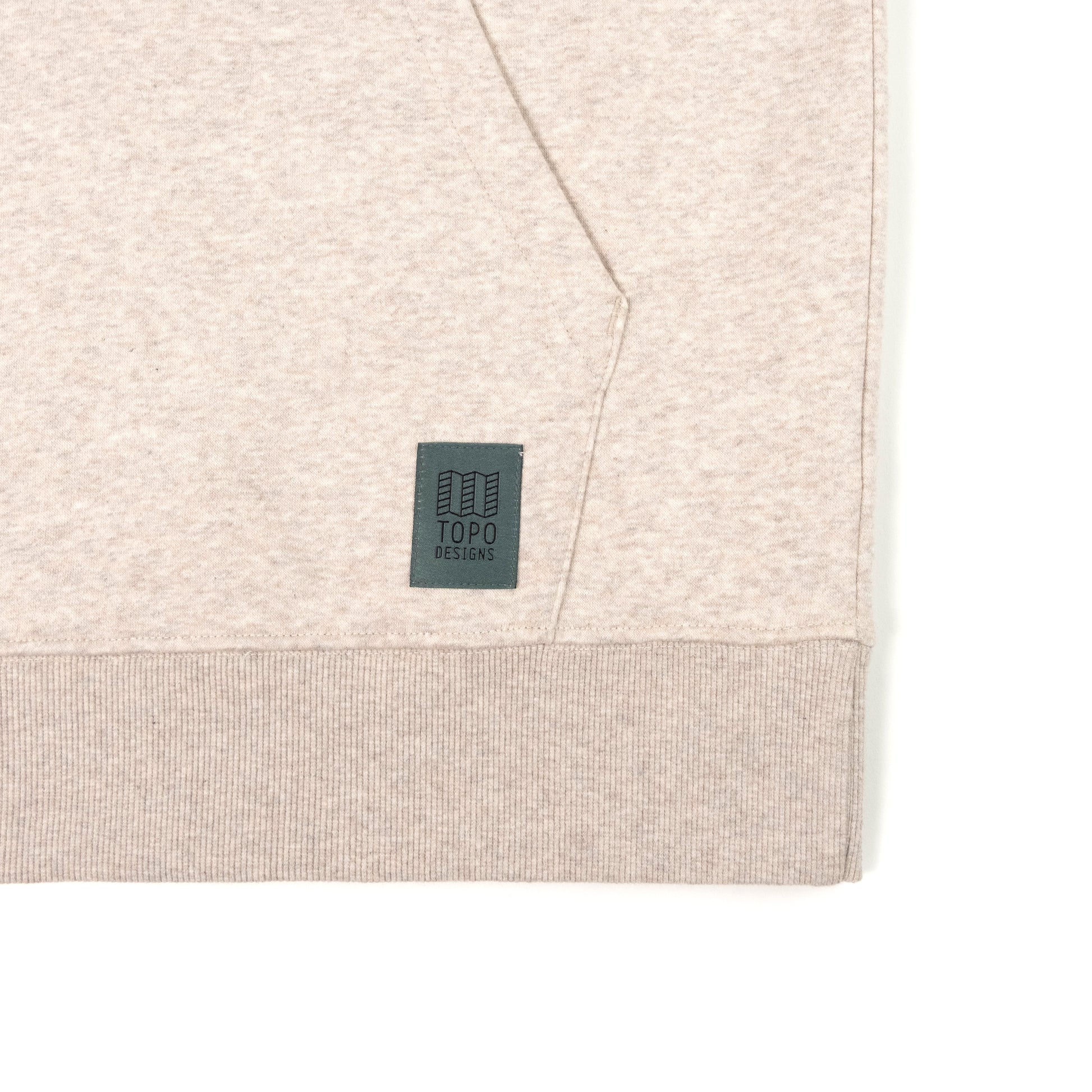 General Detail shot of Topo Designs Alpine High Label Hoodie in "Oatmeal Heather"