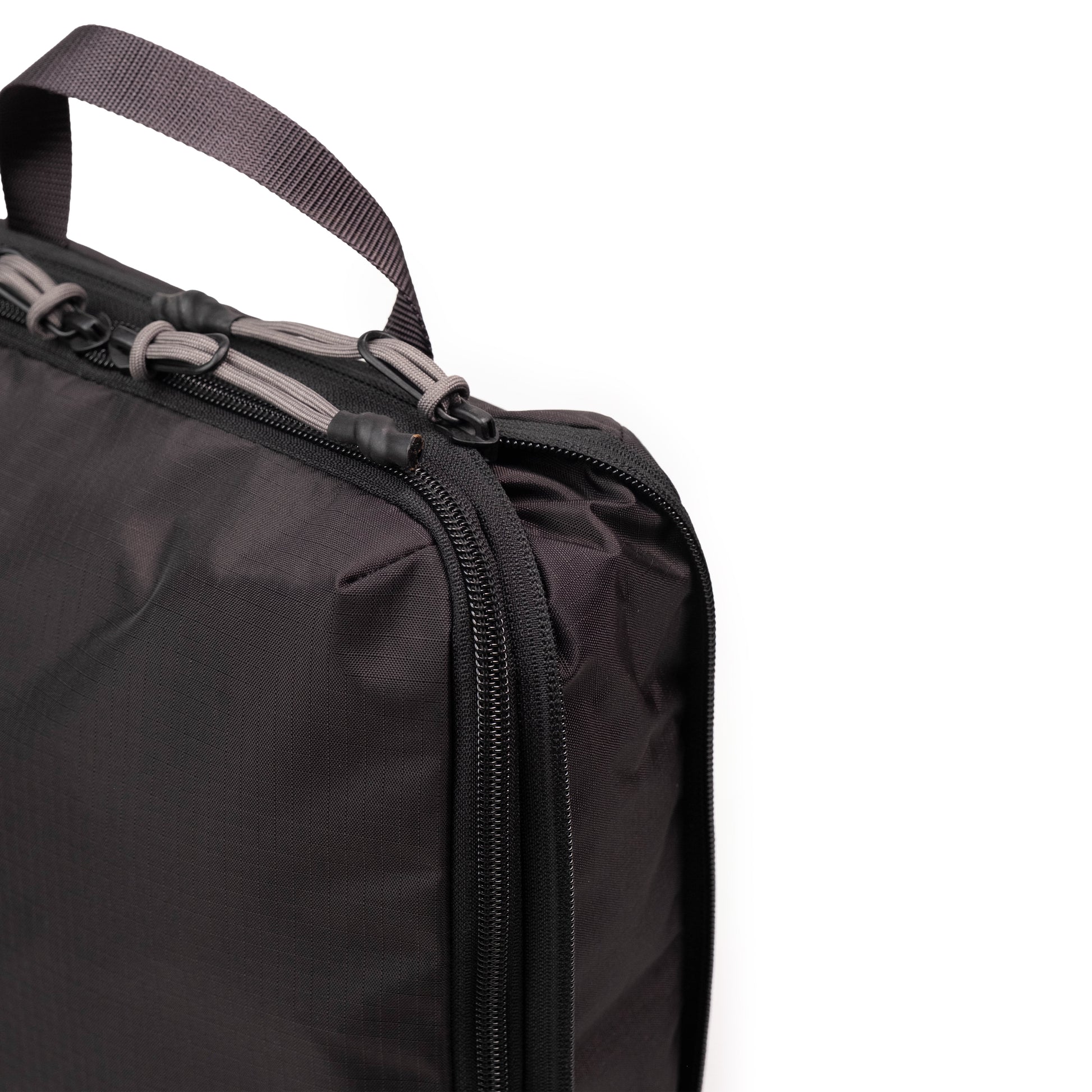 General Detail shot of Topo Designs Global Compression Pack Bag 10L in "Black / Black"