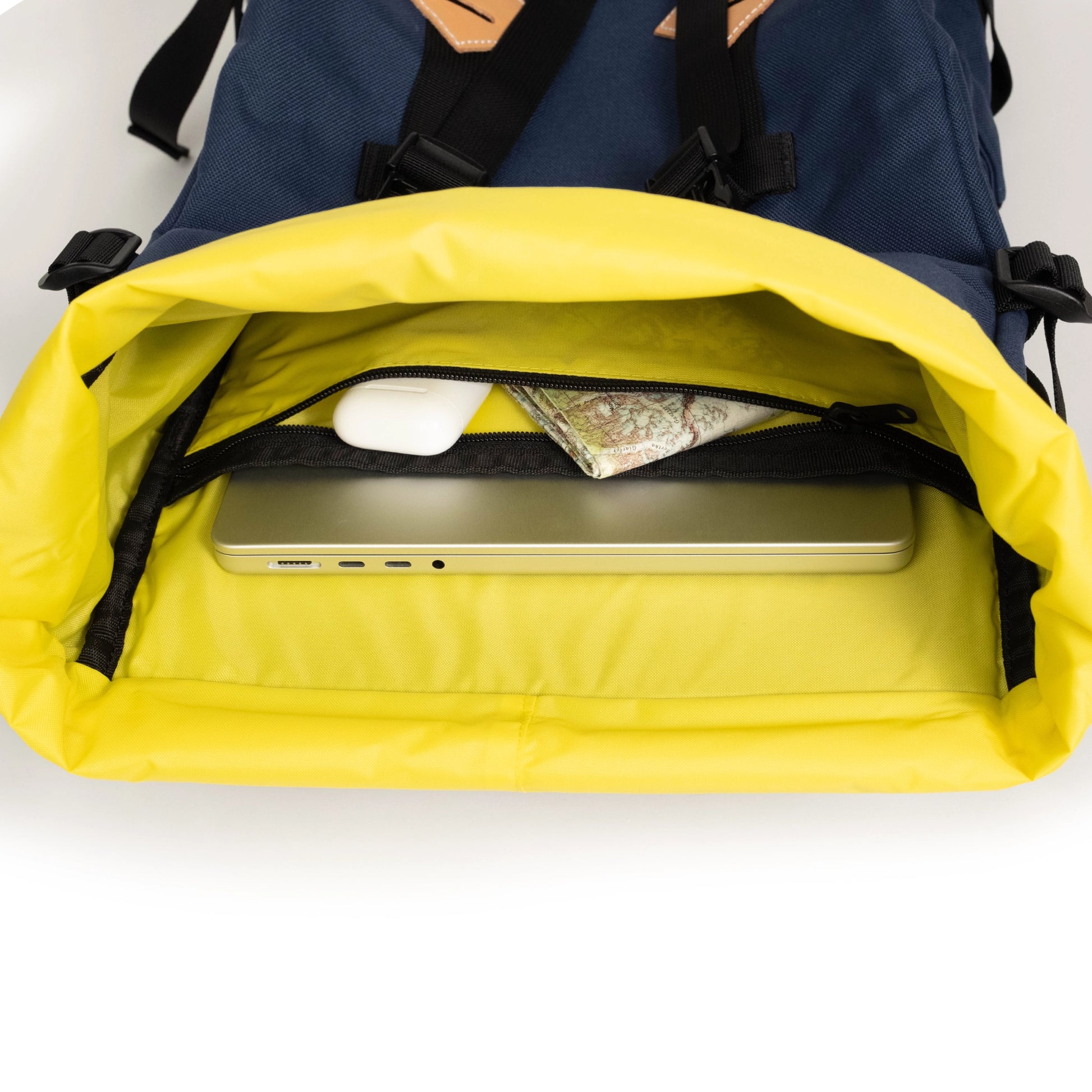 General detail interior image of internal laptop sleeve and zippered pocket inside the Topo Designs Klettersack Classic vintage-inspired rucksack backpack in "Midnight".