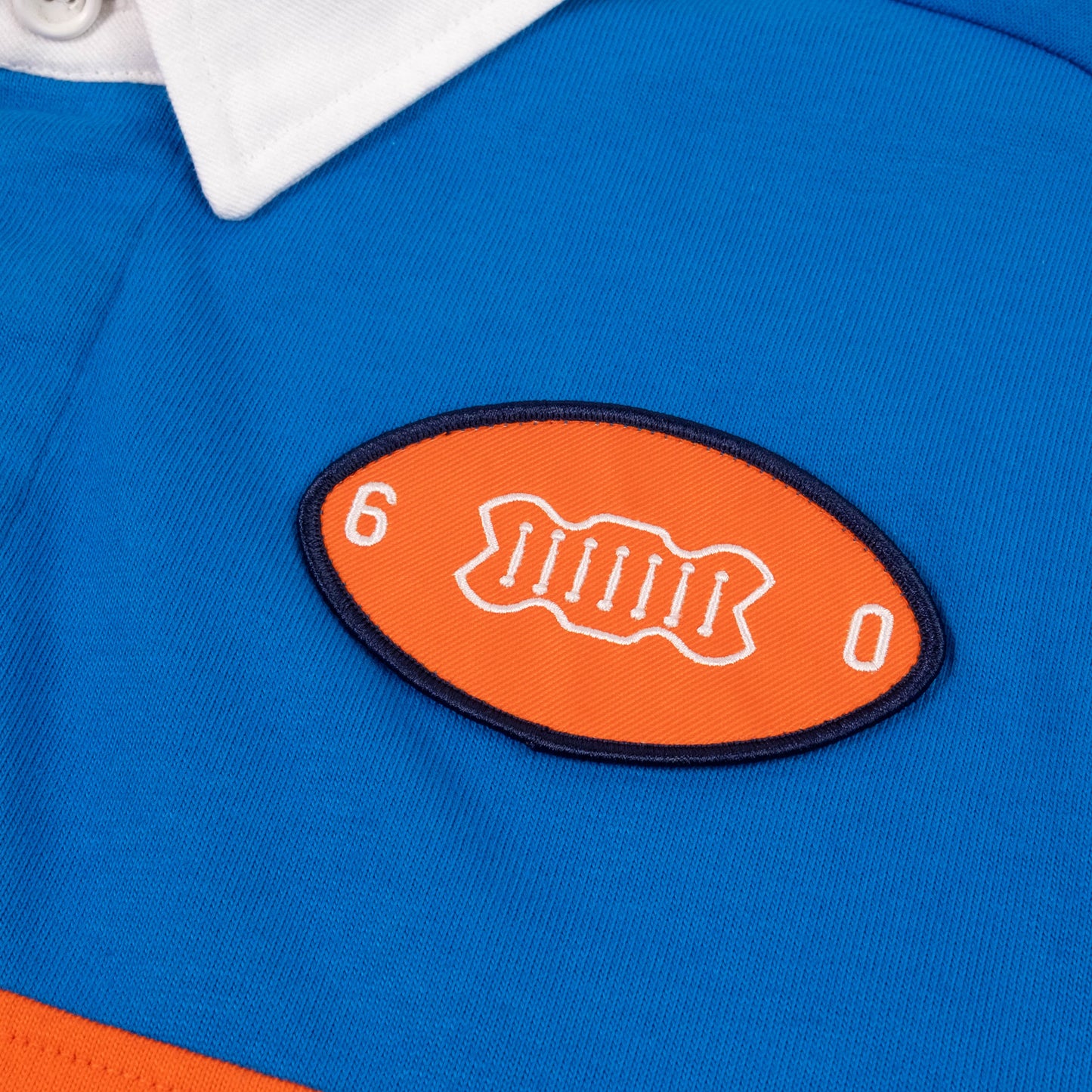 Product detail image of Topo Designs x Denver Broncos Rugby Shirt in "Directoire Blue / Scarlet Ibis"