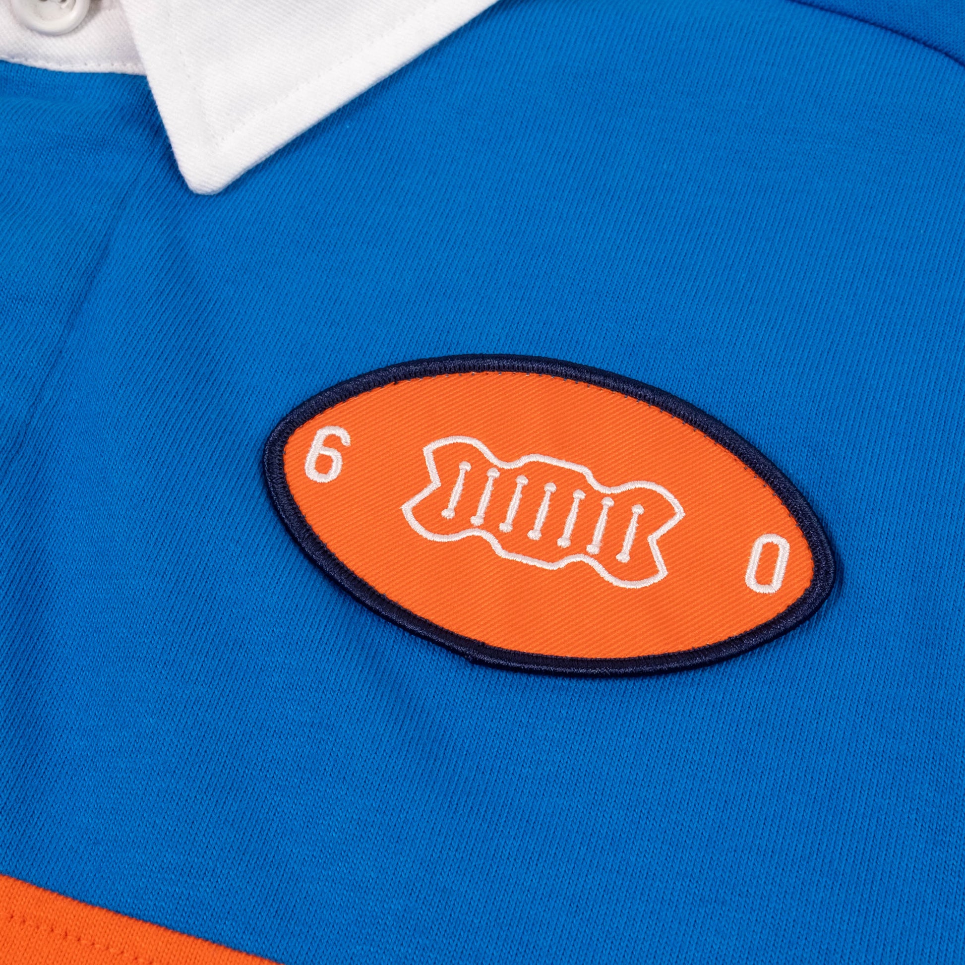 Product detail image of Topo Designs x Denver Broncos Rugby Shirt in "Directoire Blue / Scarlet Ibis"