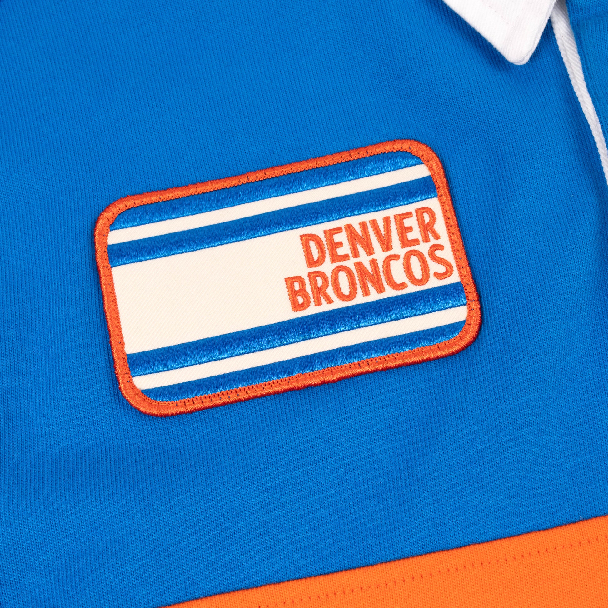 Product detail image of Topo Designs x Denver Broncos Rugby Shirt in "Directoire Blue / Scarlet Ibis"