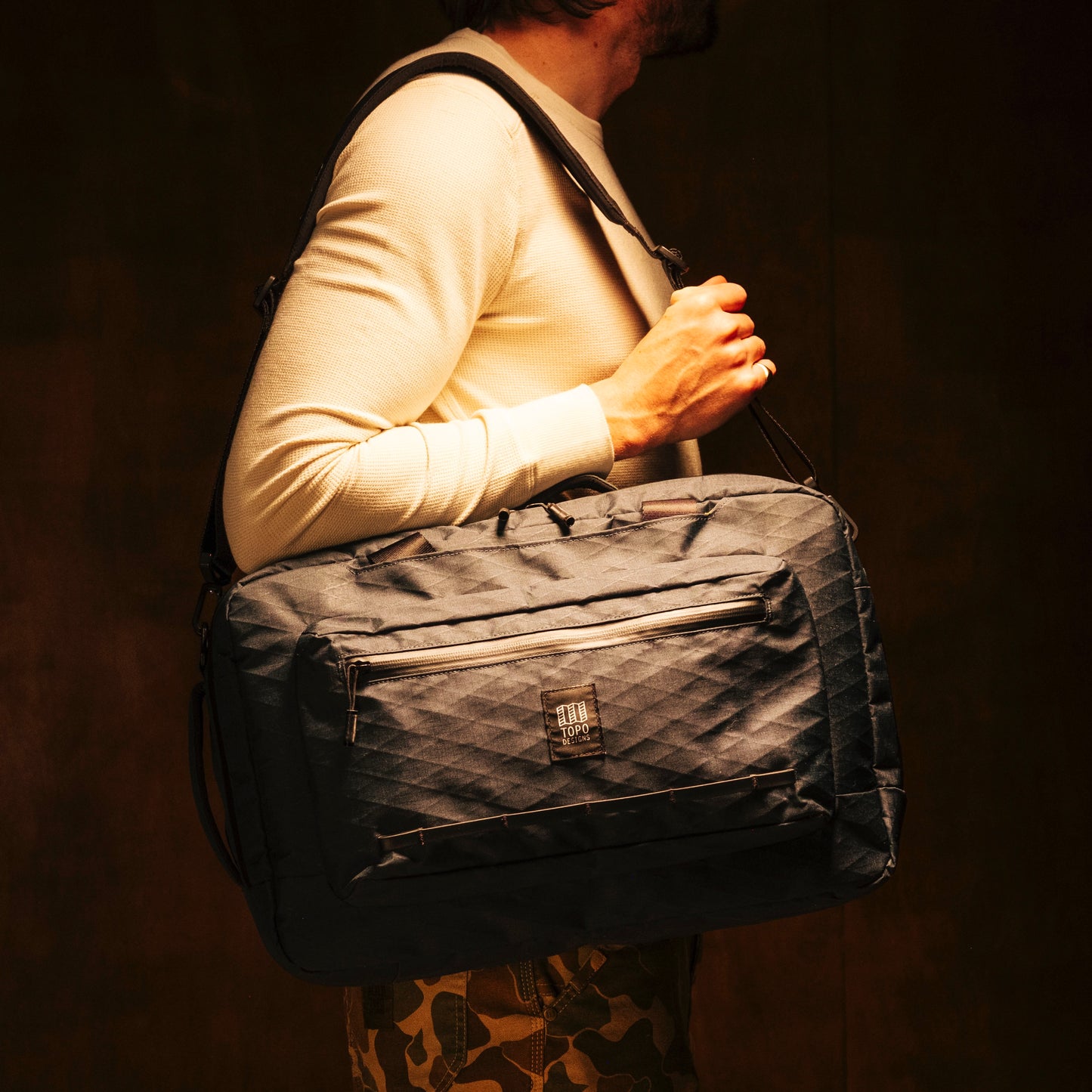 General shot of Topo Designs Global Pro 3-Way Briefcase in studio setting showing over the shoulder strap