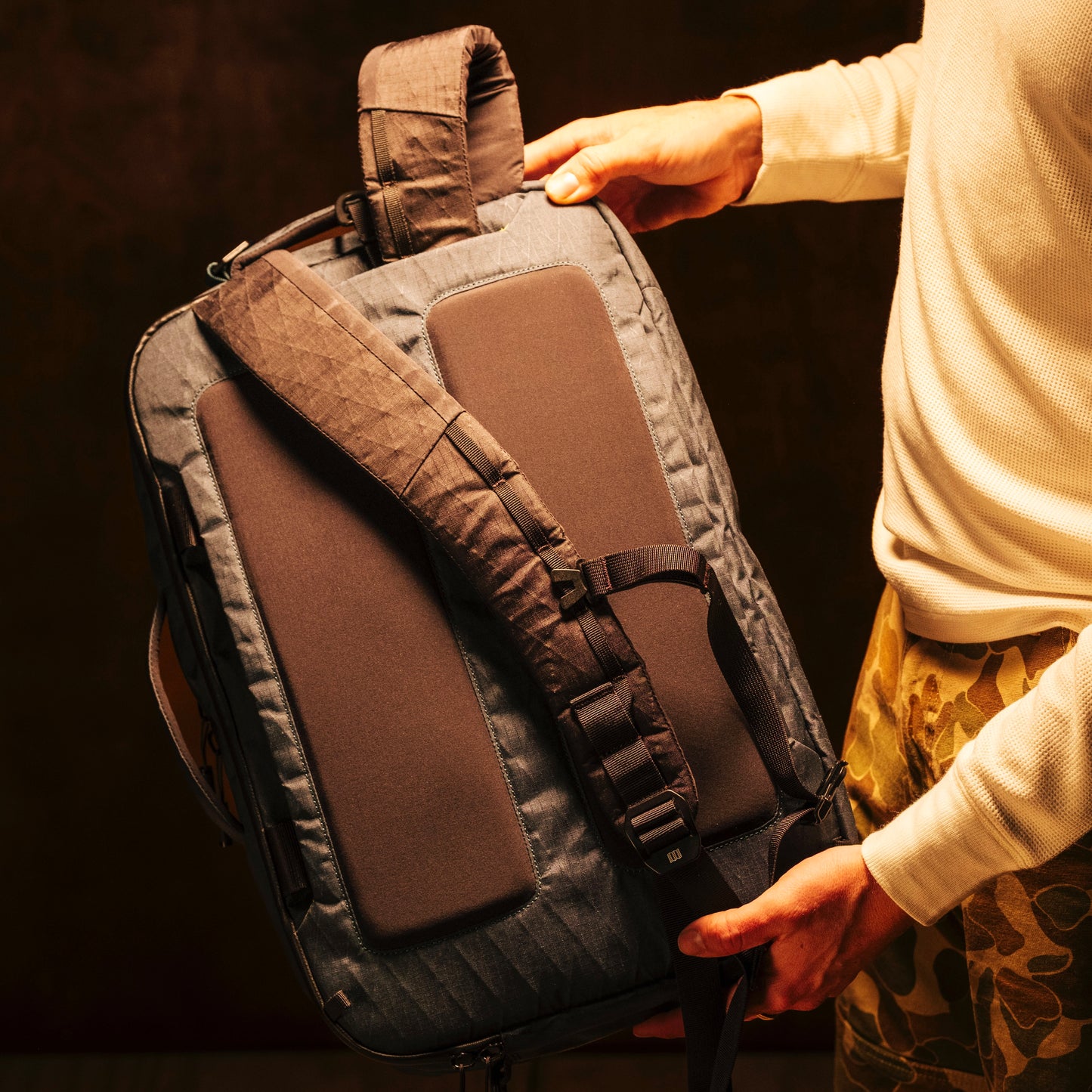 General shot of Topo Designs Global Pro 3-Way Briefcase in studio setting showing backpack straps