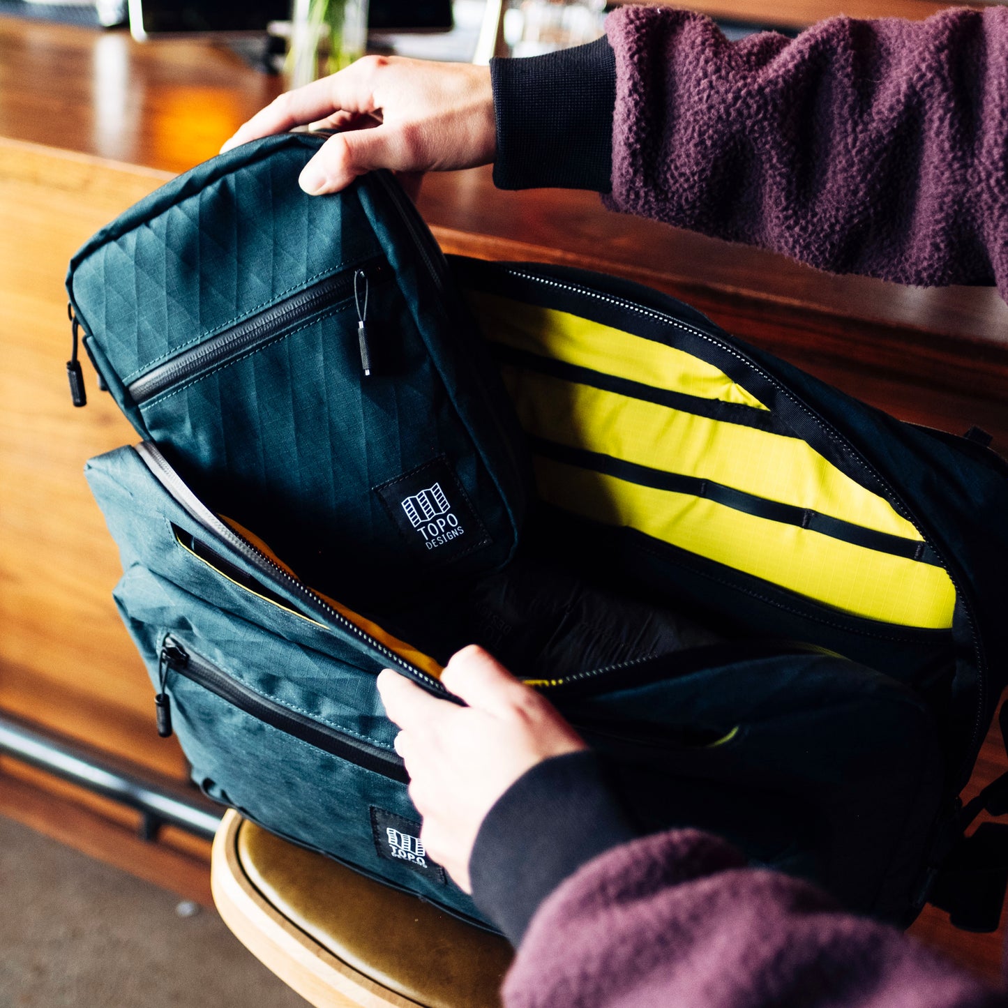 General lifestyle shot of Topo Designs Global Pro 3-Way Briefcase showing interior details