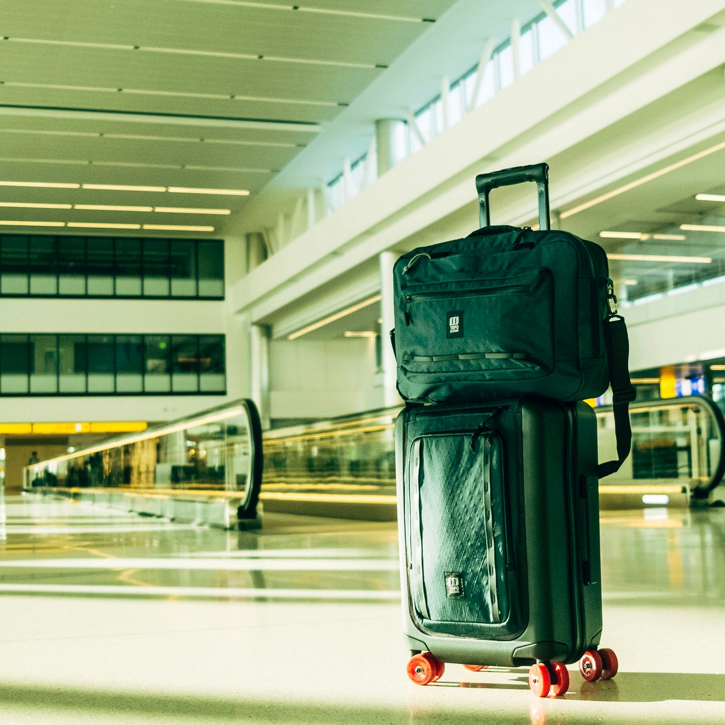 Lifestyle shot of Topo Designs Global Pro 3-Way Briefcase showing in an airport setting