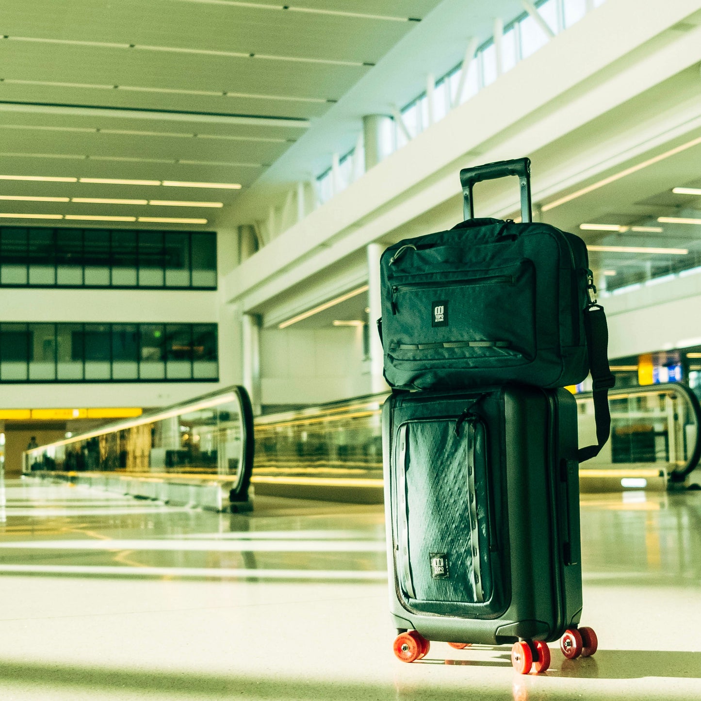Lifestyle shot of Topo Designs Global Pro 3-Way Briefcase showing in an airport setting