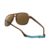 General alternate angled view of VALLON X Topo Designs sunglasses in "Brown / Brown" with sunglass arms open with strap attached.