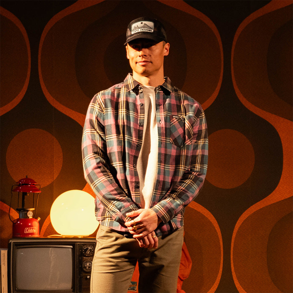 Person wearing a "Black / Goldenrod Multi" Mountain Shirt Lightweight with a dark background