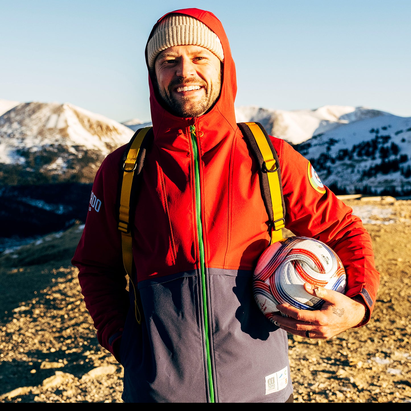 General lifestyle shot of Topo Designs x Colorado Rapids Rover Pack Classic in "Rio Red / Glacier Blue"