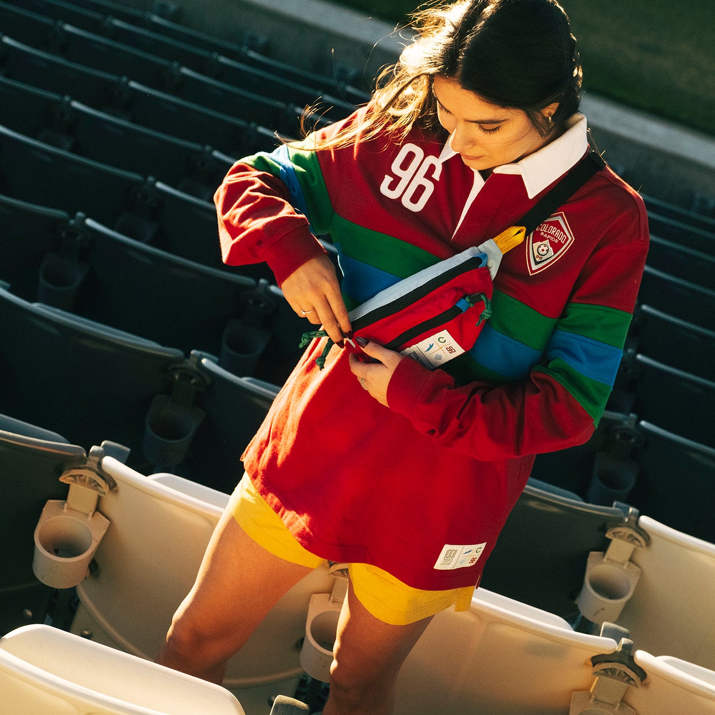 General lifestyle shot of Topo Designs x Colorado Rapids Mountain Waist Pack in "Rio Red / Glacier Blue"