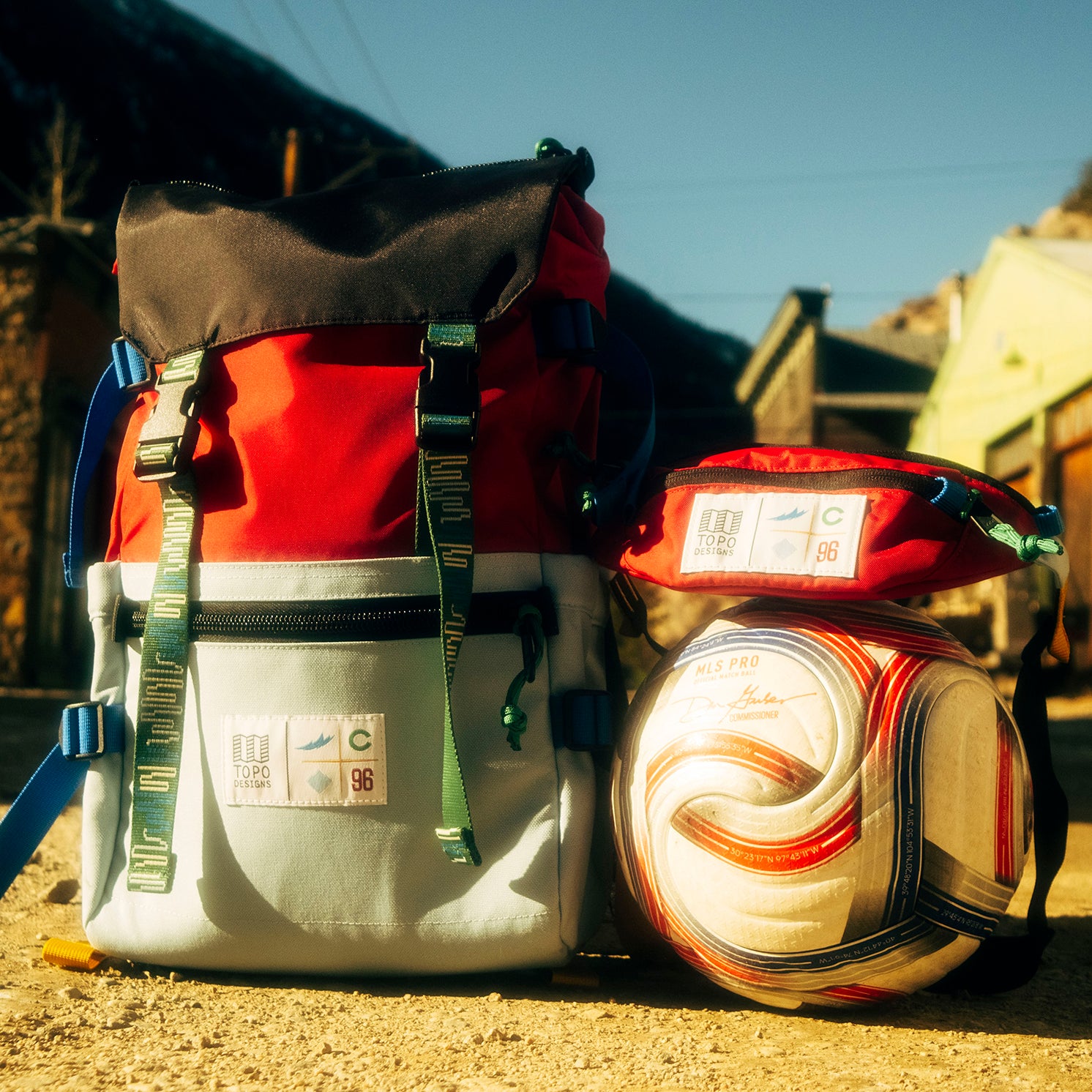 General lifestyle shot of Topo Designs x Colorado Rapids Rover Pack Classic in "Rio Red / Glacier Blue"