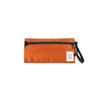 Topo Designs Dopp Kit toiletry travel bag in "Clay - Recycled" orange.