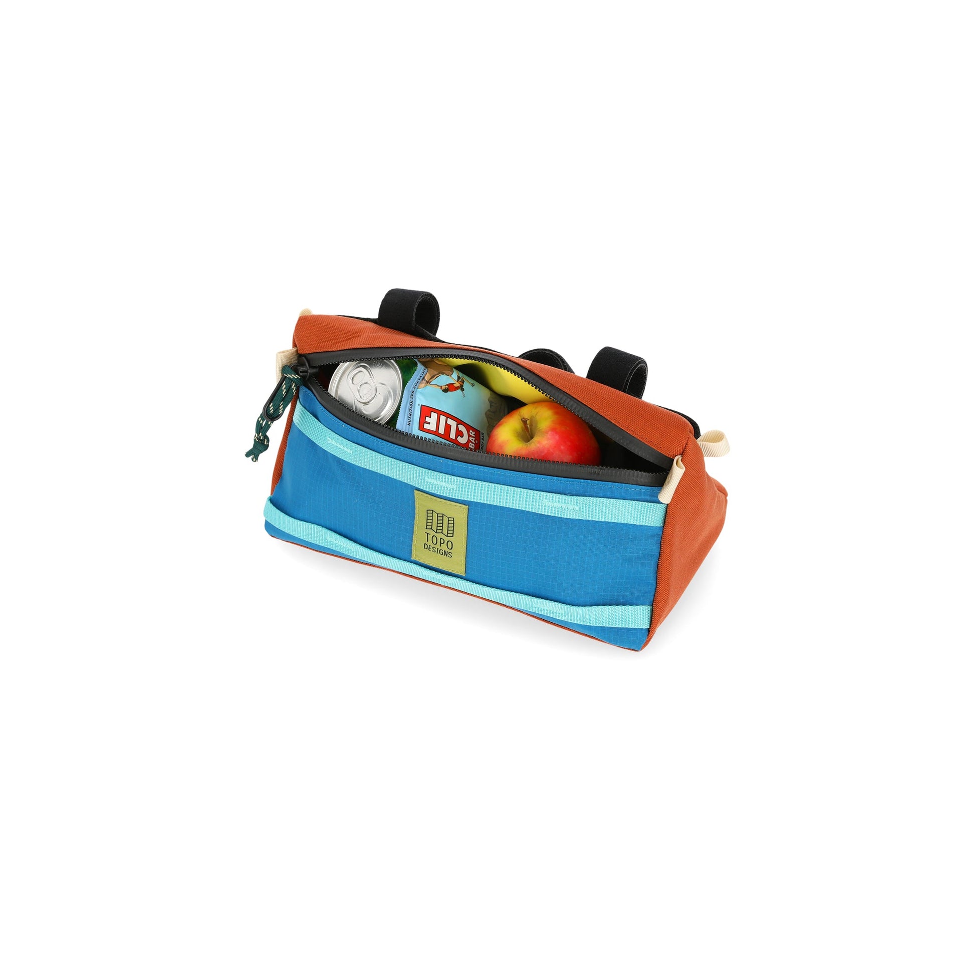 General shot of snacks inside the Topo Designs Mountain Bike Bag handlebar pack with removable shoulder strap in blue clay orange lightweight recycled nylon.