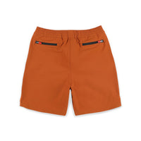 Back zipper pockets on Topo Designs Men's Global lightweight quick dry travel Shorts in "Brick" orange.