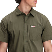 Close up model shot of Topo Designs Men's Global Shirt Short Sleeve 30+ UPF rated travel shirt in "Olive" green.